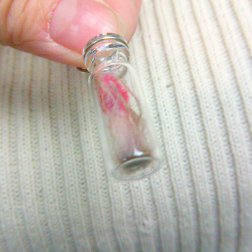 Miniature bottle with red cap mushroom and spores
